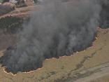 Photos: Onlookers Stop to Watch Grass Fire