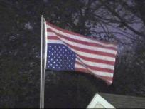 Garland Man Flying American Flag Upside Down