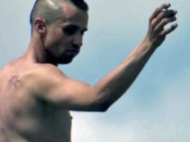 Man Clad in Nothing But Smile Dances on Billboard