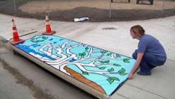 Artist Decorates Storm Drains in Denton