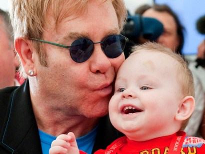 Elton John kisses baby Lev during a news conference at a Ukrainian orphanage for HIV-positive children.