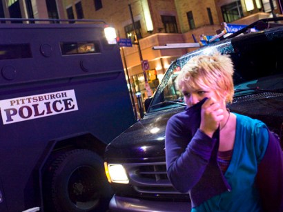 A bystander covers her face after police used chemical irritants at the University of Pittsburgh in Pittsburgh during the G20 Summit.