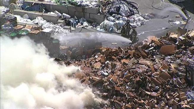 Fire in a mountain of trash kept firefighters busy Monday at a Carrollton recycling plant.