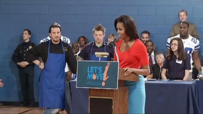 First lady Michelle Obama joined with Top Chef contestants and Dallas Cowboys players to encourage healthy eating at a Dallas elementary school.