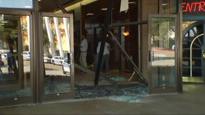 Dallas police say a naked man covered only with a blanket drove a truck into the Southwest Center Mall Monday morning and broke into a sporting goods store to steal pants and some new Air Jordans.