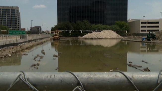 Neighbors raised concerns about standing water at an apartment construction site in Dallas. The developer said the area, which shows no signs of mosquito larvae, would be drained by Wednesday.