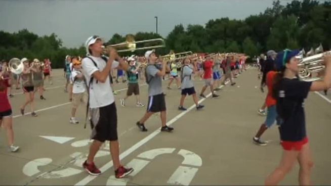 High school marching bands start their school year preparations while adjusting to the triple digit temperatures.