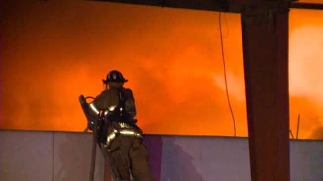 Flames ripped through a vacant warehouse in Dallas early Tuesday morning.