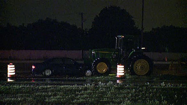 A car drove through construction cones at the westbound Midway exit and slammed into a tractor Thursday morning, police said.