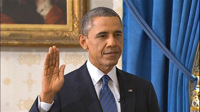 President Barack Obama is sworn in for a second term by Supreme Court Chief Justice John Roberts in the Blue Room of the White House.