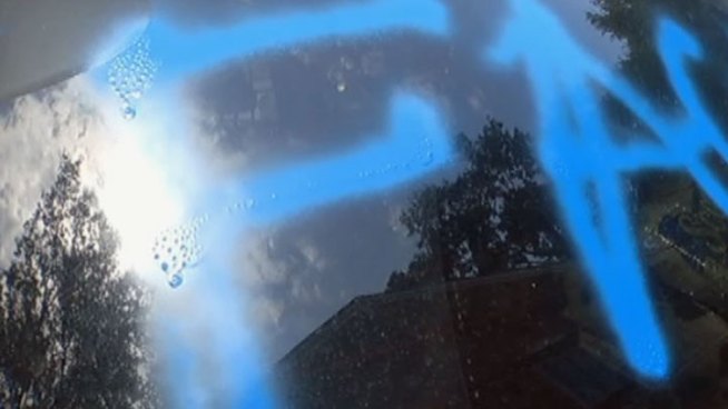 Arlington's Lake Interlochen neighborhood is cleaning up after vandals spray painted streets, cars and homes, in some cases the attacks were personal.