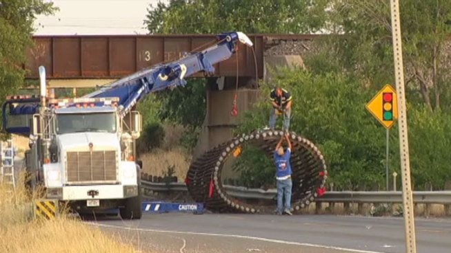Highway 114 in far north Fort Worth will stay closed for now after a semi truck's load hit a train bridge near Farm to Market Road 156.