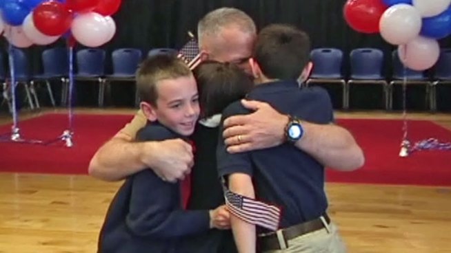 Marine Lt. Col. Patrick Johnson's homecoming was a special surprise for his three children during a school assembly at Dallas Academy Friday.