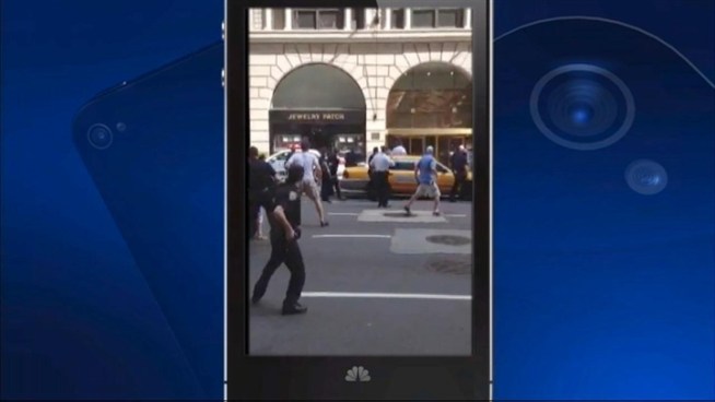 Cell phone video of police opening fire on a man they were chasing near Times Square Saturday afternoon.