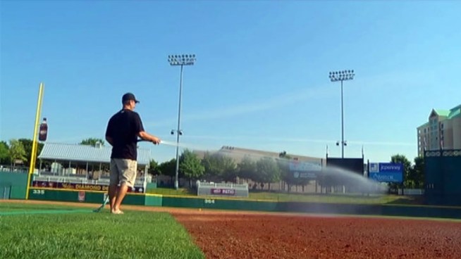 Assistant groundskeeper Michael Turk and the grounds crew at Dr Pepper Ballpark are working to make the Frisco RoughRiders venue is ready for the home opener on Thursday. Team president Scott Sonju says The Texas Rangers' success means a lot of interest in baseball locally.
