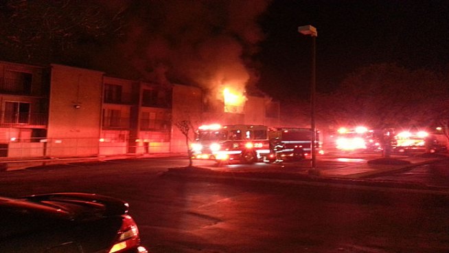 Firefighters worked to extinguish a two-alarm fire at a North Dallas apartment complex Friday morning, the same location as a fire only months ago.