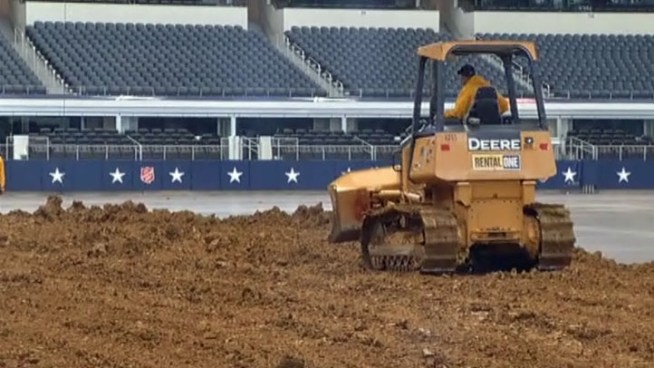Dirt is piling up at Cowboys Stadium in Arlington as crews change the football field into a motocross course for the Monster Energy Supercross Race this weekend.