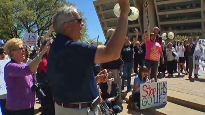 Demonstrators at a Dallas rally Friday showed their support for cuts to women's health care and any federal programs that support Planned Parenthood.