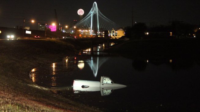 Police said a stolen truck was abandoned and rolled into a pond near downtown Dallas early Friday morning.