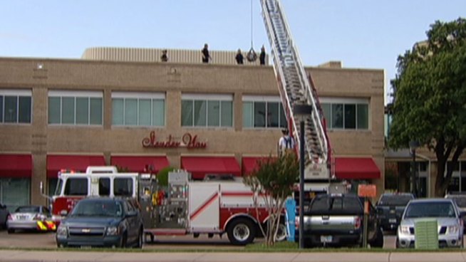 Emergency responders rescued an injured man from the roof of a shopping center in Arlington Tuesday.
