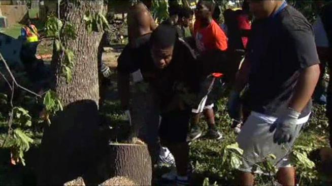 The Bowie High School football team pitched in to help clean up tornado damage in a hard-hit area of Arlington on Thursday.