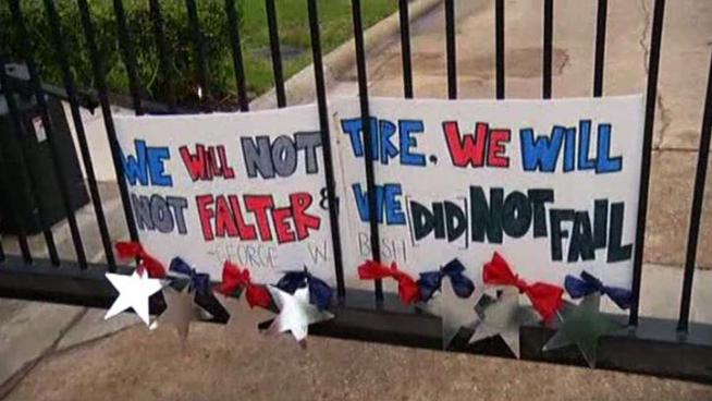 People have flocked to former President George W. Bush's Dallas home since news of Osama bin Laden's death to leave balloons and thanks.