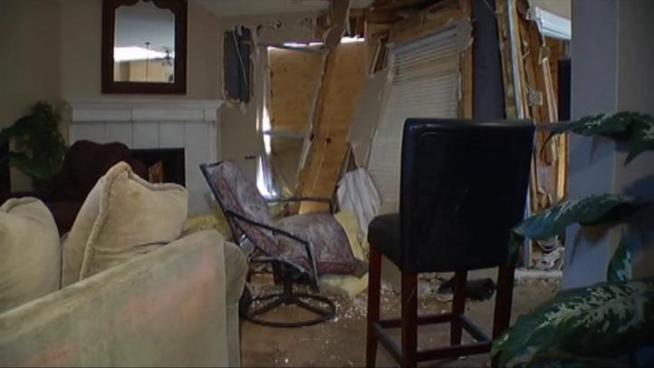 Car crashes into a home in Lewisville after fleeing from traffic stop at nearby intersection. Residents were not hurt. Suspect was taken to the hospital then released to police.