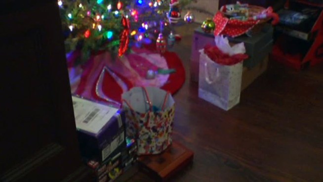 A burglar unwrapped the presents under a Dallas home's Christmas tree before stealing them.