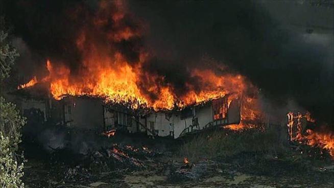 A fast-moving brushfire southeast of Dallas destroyed several homes.
