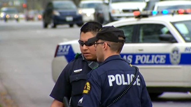Dallas police said two pit bulls attacked a police officer and a man in a wheelchair. The officer fatally shot one of the dogs, and the other dog got away.
