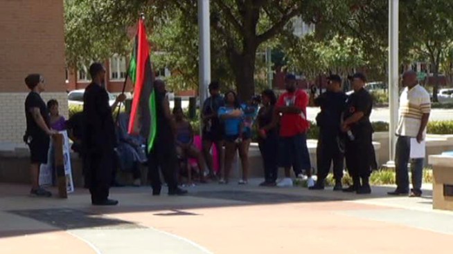 Protesters outside Dallas Police headquarters held signs claiming police brutality after the shooting of James Harper last week.