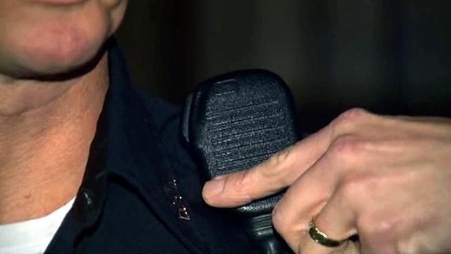 Dallas police said a shot fired at an officer hit his radio's lapel microphone.