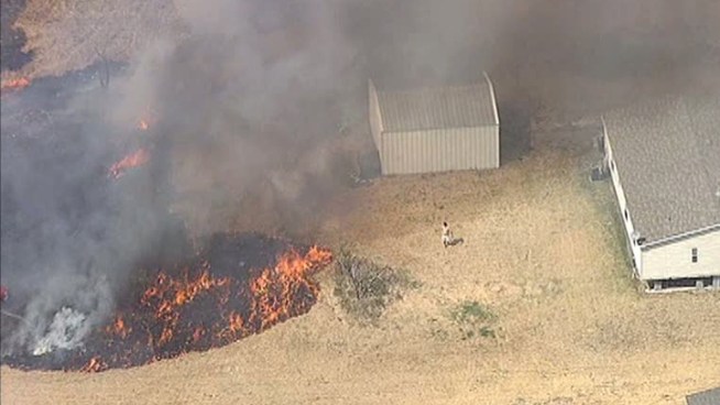 Residents used garden hoses to fight off a grass fire.