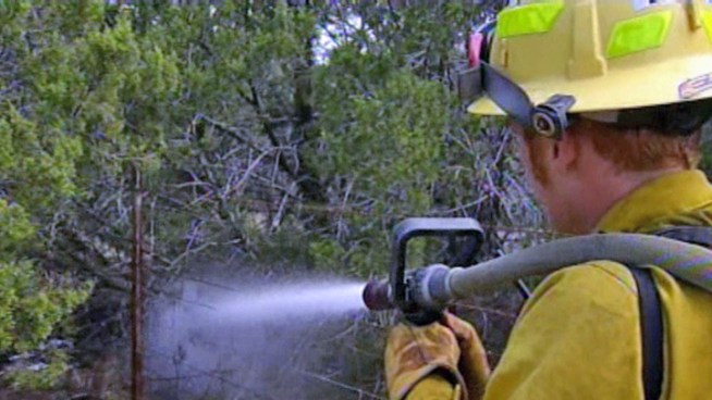Firefighters are working in excessive heat to contain two wildfires in Palo Pinto County east of Possum Kingdom Lake.