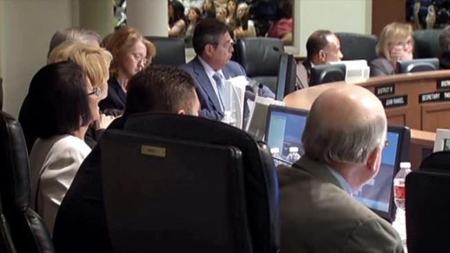 Trustees vote to eliminate 553 positions, but it appears few teachers would lose their jobs.