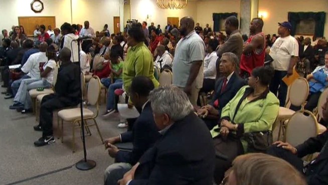 Police answered questions for about 200 people in wake of the fatal shooting of a man in front of his children by an officer who was being dragged by the man's SUV.