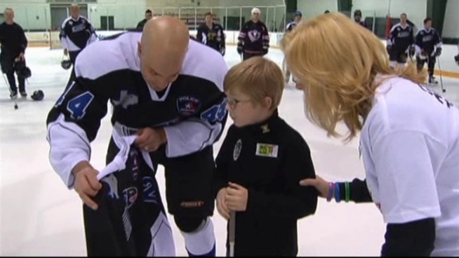 Arlington honors family of fallen officer and provides special moment for son battling fatal disorder.