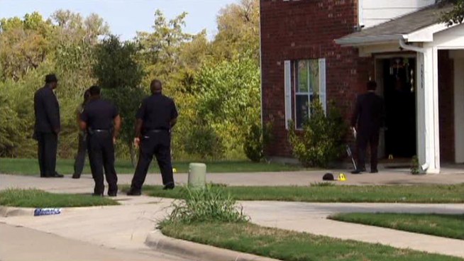 Dallas police say a woman fatally shot one of two people who kicked in the door to her house.