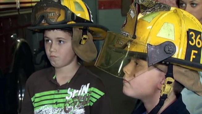 The family serves up goodies to the responders who helped them after a hit-and-run crash in front of the fire station.