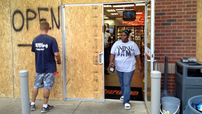 Gas stations in New Orleans are crowded with people topping off their tanks, and some stores and restaurants say they plan to stay open as long as they can.