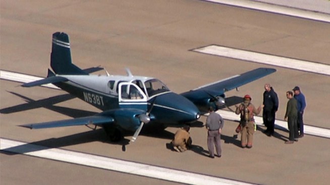 With a landing gear not locking into place, a pilot makes an emergency landing in Arlington Wednesday.