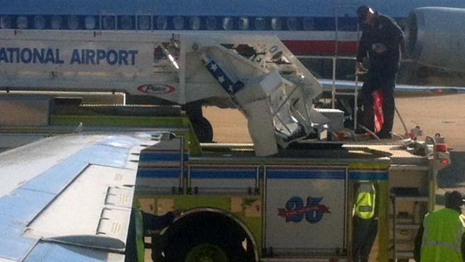 The wing of an American Airlines plane struck a firetruck waiting at a gate Thursday at Dallas/Fort Worth International Airport.