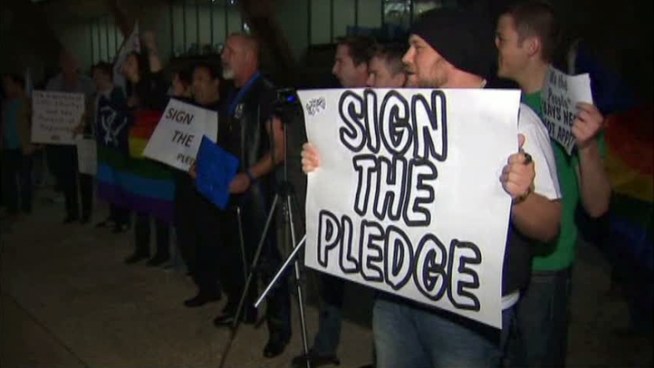 Demonstrators asked Dallas Mayor Mike Rawlings to sign a pledge supporting same-sex marriage.