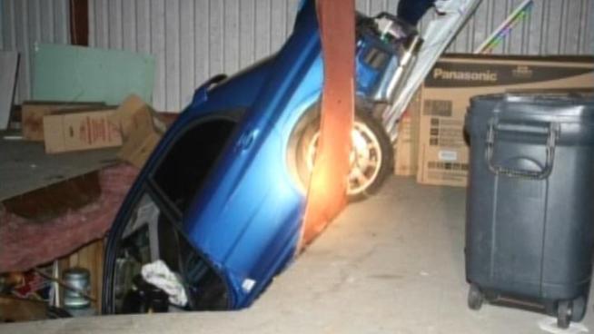 A Santa Fe septic system company is cleaning up after a car crashed nose first through its roof.