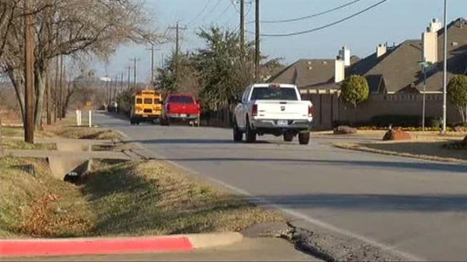 Administrators evaluate the road conditions after a car strikes a student.