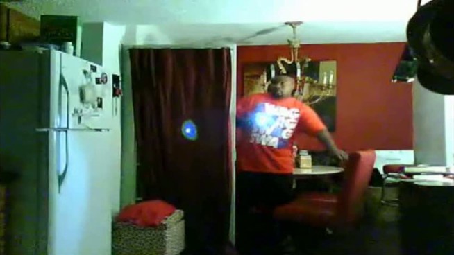 A surveillance camera in the kitchen captured a burglar kicking in a Dallas home's back door and then walking in with a flashlight.