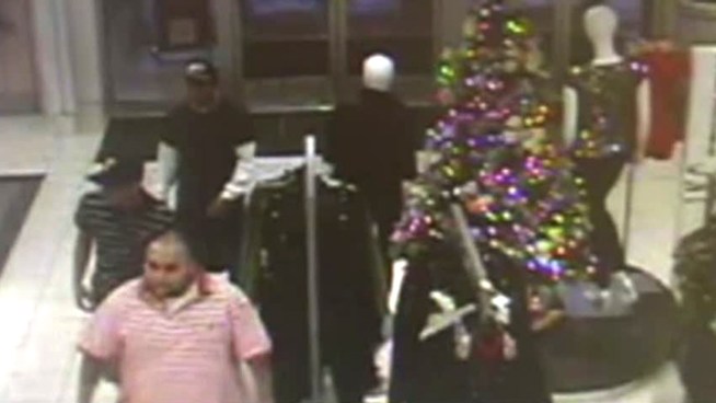 Surveillance video shows three thieves stealing approximately $19,000 worth of watches from a Macy's in Garland.