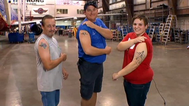 Three Southwest Airlines employees wear their company love on their arms.