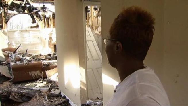 Remica Cox walked through her home destroyed by Saturday's wildfire.