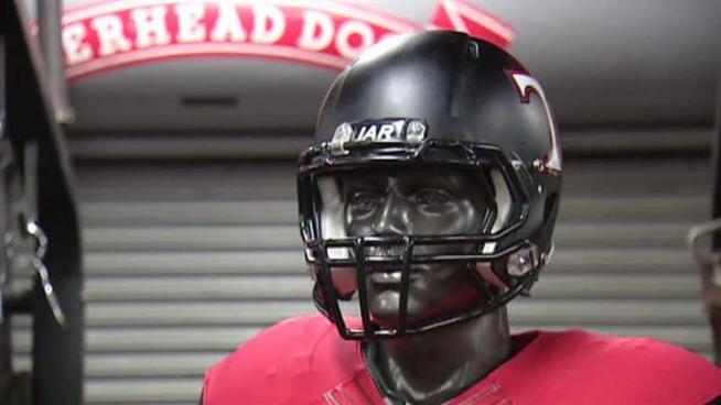 Jason Dibble, a coach at Trinity, shows off the team's Nike Pro Combat uniforms